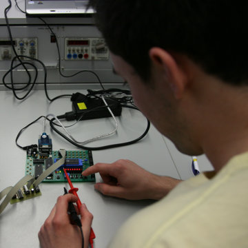 technician examining circuit board